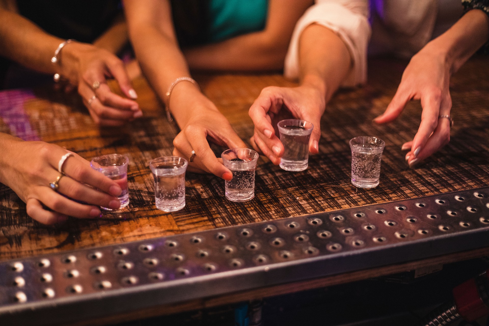 Female Hands about to Pick up Shot Glass